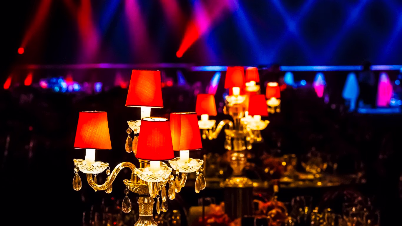 Ornate red candelabras with vibrant stage lighting at a Las Vegas event