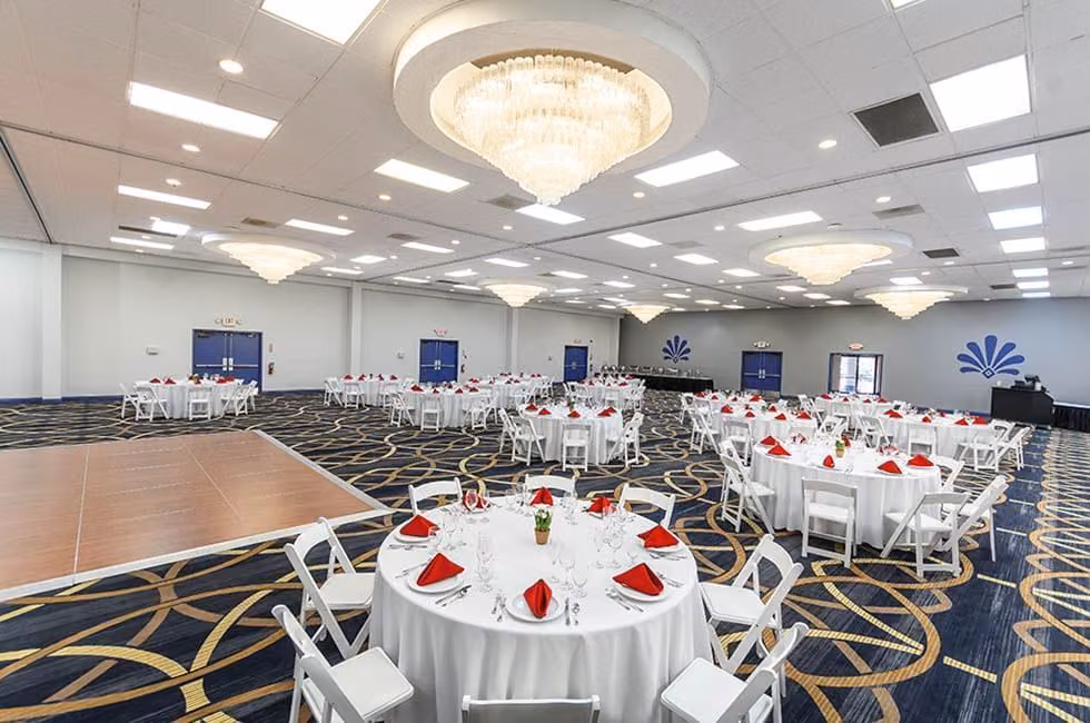 Apollo Ballroom with crystal chandeliers, a dance floor, and banquet tables