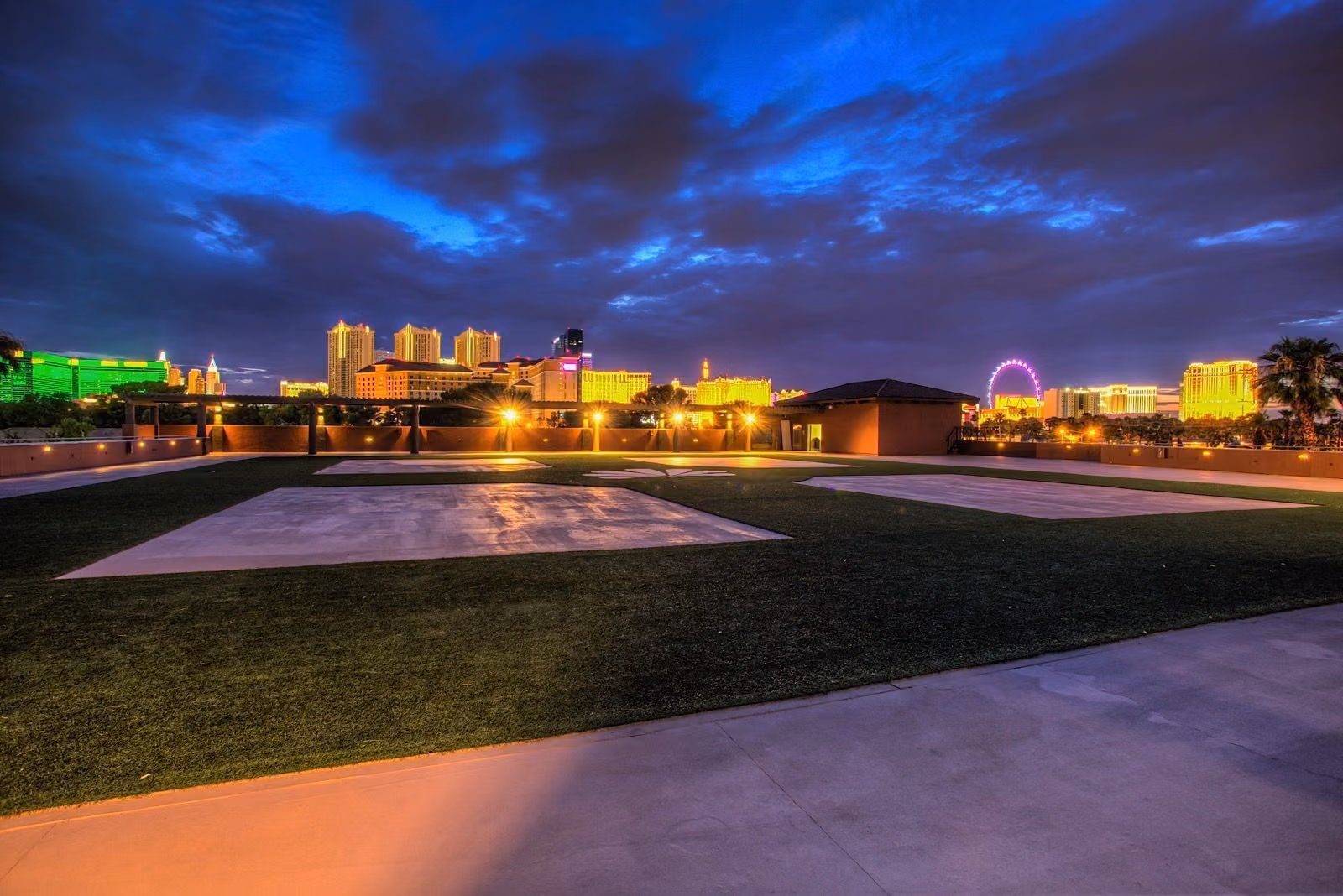 Alexis Park rooftop terrace at dusk with the lit Las Vegas Strip skyline beyond