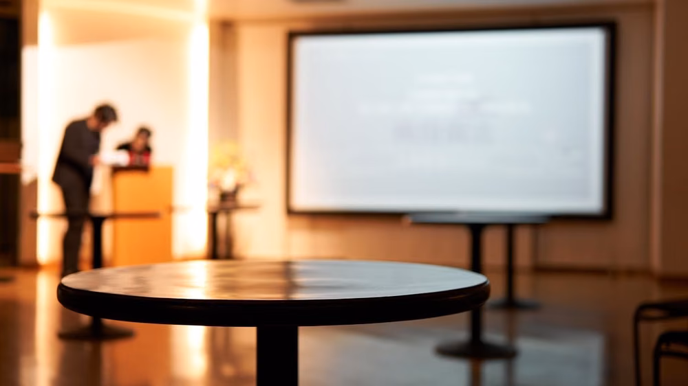 Corporate event stage setup with live presentation screens and AV production